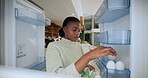 Eggs, fridge and packing with black woman in kitchen of home for diet, health or nutrition. Closing door, food and groceries with pov of African person in apartment for organic meal preparation