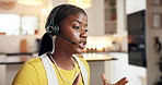 Black woman, consultant and talking with headset in home for online advice or customer service. Female person, agent or remote work with help for telecommunications or virtual assistance in house