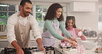 Parents, girl child and baking cupcakes in home, happy and learning for skills, food or development in kitchen. People, mother and dad with teaching, dessert or smile for helping hand at family house