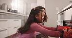 Woman, daughter and cupcake in oven for baking, learning or help for support and bonding in home. Mom, girl kid and growth for bakery skills with family in kitchen for cake, baked goods and happiness