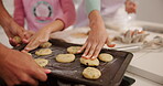 Baking, cookies and hands of child with parents in kitchen of home for bonding, development or learning. Cooking, dessert or food with mom and dad teaching girl how to bake at counter in apartment