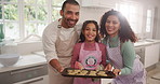 Parents, girl and face with tray, cookies and smile in kitchen with baking in family house. Mom, dad and child in portrait with biscuit, dessert or results for cooking skills at apartment in Mexico