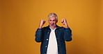 Face, dancing and senior man in studio, smile and celebration on yellow background. Portrait, mockup space and mature person with happiness, cheering and excited with victory, winning and movement