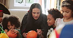 Halloween, kids and drawing on pumpkin with mother or parent for learning in home. Children, holiday and celebration with vegetable for decoration, writing or creative art with foster family at party
