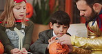 Halloween, children and drawing on pumpkin with father, parent and talk for learning in home. Kids, holiday and celebration with vegetable for decoration, writing or creative art with family at party