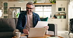 Mature, happy man and laptop with documents in home for finance, tax return or investment profit. Male person, calculator and paperwork with computer for financial assessment, planning or audit 