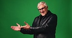 Face, presentation and smile of mature man on green screen for marketing, offer or promotion. Advertising, hand gesture and mockup with happy person on studio space for announcement or information