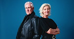 Serious, fashion and face of mature couple in studio with confidence for trendy, cool and casual outfit. Pride, crossed arms and portrait of man with woman for stylish clothes by blue background.
