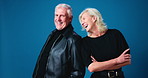 Laugh, fashion and mature couple in studio with confidence for trendy, cool and casual outfit. Happy, crossed arms and portrait of man with woman for stylish clothes with marriage by blue background.