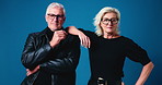 Face, fashion and senior couple with glasses in studio for timeless style, confidence and cool. Portrait, trendy man and woman with eyewear for vision, retirement and smile on blue background