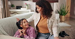 Phone, secret or social media with mother and daughter on sofa in home for safety or security. App, chatting or gossip with girl child and single parent in apartment living room for responsibility