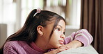Sofa, sad and child thinking in home for trauma, abuse victim or mental health crisis. Living room, unhappy girl and kid with reflection for depression, stress or thoughts with anxiety for mistake