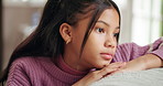 Sofa, sad and kid thinking in home for trauma, abuse victim or mental health crisis. Living room, unhappy girl and child with reflection for depression, stress or thoughts with anxiety for mistake