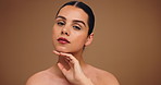 Skincare, hands and face of woman in studio for beauty, facial treatment and dermatology. Spa aesthetic, space and portrait of person with for natural glow, shine and wellness on brown background