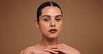Makeup, lipstick and face of woman in studio for cosmetics, beauty and aesthetic glow. Self care, foundation and space with female person on brown background for luxury, cosmetology and makeover