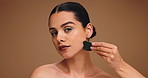 Woman, face or massage with gua sha or jade for skincare or anti aging on a studio background. Portrait, female person or model with beauty tool for spa, dermatology or facial treatment on space