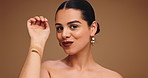 Face, woman and swatches of makeup in studio for beauty, cosmetics decision and makeover. Portrait, female person and color for foundation choice ,facial glamour and shine results on brown background