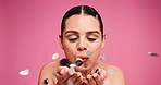 Makeup, confetti and woman in studio, blowing and dermatology on pink background. Mockup space, glitter and person with foundation, cosmetics and wellness with beauty, skincare and elegant face