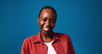 Laughing, black woman and face in studio for funny joke, humor or endorphins on blue background. Mockup space, excited female model and silly or goofy mood with confidence and casual portrait