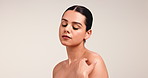 Shoulder, beauty and skincare with woman in studio for aesthetic, glow and skin wellness. Cosmetics, model and dermatology with self care, health and touching neck on white background with space