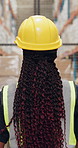 Back, helmet and woman in warehouse, supply chain and safety with distribution center. Person, hard hat and employee in factory, walking and cargo process with manufacturing development and engineer