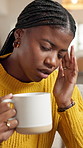 Black woman, headache and coffee on sofa with stress, pain and frustrated in living room at home. African person, migraine and burnout with vertigo, brain fog or fatigue with tea in lounge at house