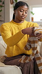 Laundry, black woman and fold clothes on sofa for housekeeping, organizing fabric or hygiene. Housewife, happy person and packing washing in lounge for domestic chores, cleaning and housework in home