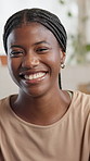 Face, funny and black woman with smile, home and confident personality with humor. Apartment, portrait and African person with happiness, laughing and relax with pride, calm and joke in living room