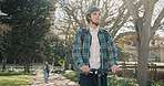 Man, college student and scooter for transport at campus, helmet and commute for back to school. Person, sustainability and mobility on search for direction to class, learning or university education