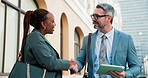 Business people, meeting and handshake with tablet in city for partnership, b2b or agreement. Businessman, woman or colleagues shaking hands with smile or technology for project deal in an urban town