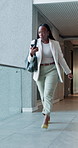 Late, phone and urgency with business black woman in workplace hallway for delay or rushing. App, hurry and panic with fast employee person in corridor of office for appointment, meeting or schedule