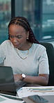 Serious, woman and employee with laptop, office or data analysis with paperwork, reading and online. Typing, financial analyst and black person with document for wealth management, graph and research