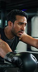 Boxer, man and tired with sweating at gym for fight challenge, intense training and recovery. Combat sports, champion and exhausted in boxing ring for match performance, breathing and fitness break