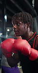 Boxing, fitness and black man in gym for sports, workout or challenge with power. African person, boxer and punch for combat training, fight practice and exercise for self defense in health club