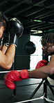 Sport, punch and men boxing in gym with gloves, strength and cardio training in practice match. High intensity, skill development and people sparring in ring, powerful impact or defence in fist fight