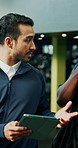 Tablet, tour and walking with men in gym for membership, sign up or subscription option. App, conversation or fitness with client and manager in health club for discussion on training schedule