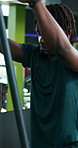 Instructor, teaching and athlete with cable machine at gym for workout technique, guidance or help. Pulley, people and fitness coach with advice for exercise form, training instructions and learning