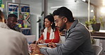 Man, writing and office meeting for graphic design, tablet and review for brainstorming at company. Person, designer group and notebook with team, planning and editing for project at creative agency
