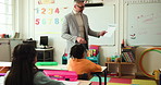 Man, teacher or document with classroom for math lesson or assessment in elementary school. Male person, educator or results with kids, learners or thumbs up for test, youth development or progress