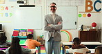 Mature man, teacher and face with confidence in elementary school for education or learning service. Portrait, male person or educator with smile or arms crossed for youth development in classroom