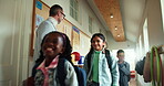 Education, teacher and line with kids in school for morning class, welcome and support. Learning, future and knowledge growth with group of students and man on campus for lesson, care and connection