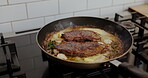 Cooking, pan and steak on stove in kitchen of restaurant for cuisine, fine dining or meal preparation. Flavor, frying and protein with meat in skillet for diet, gourmet nutrition or health closeup