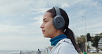 Thinking, woman and headphones at beach for travel ideas, holiday vision and listening to music. Thoughts, female person and exhale with fresh air, streaming podcast and reflection for ocean vacation
