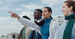 Pointing, relax and couple of friends at beach for vacation, bonding and gen z community. Diversity, conversation and travel destination with group of people on promenade for discussion and weekend