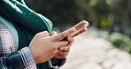 Typing, message and hands with smartphone, nature or communication on social media for exam schedule. Outdoor, student and person with mobile for digital chat, online or research for course selection