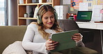 Happy, tablet and woman on sofa with headphones for watching movies, online videos and streaming. Home, living room and person on digital tech with subscription for entertainment, internet and relax