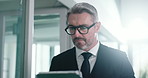 Walking, businessman and serious with tablet, office or browse for investment opportunity on website. Online, investor and mature person with tech for financial report, review or stock market updates