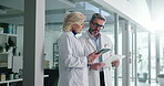 Teamwork, doctors and people with tablet, hospital or discussion with medical research or diagnosis. Talk, mature man and woman with tech for treatment plan, collaboration and conversation in clinic