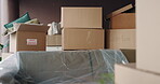 Boxes, moving in or relocation with empty room in new house for property investment and unpacking. Real estate, rent or mortgage home with cardboard package for apartment, housing or accommodation