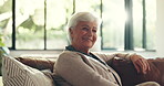 Face, senior woman and smile in home, weekend and comfortable on couch in living room and apartment. Happy, elderly person and relax in lounge, healthy and peaceful in house, calm and retirement